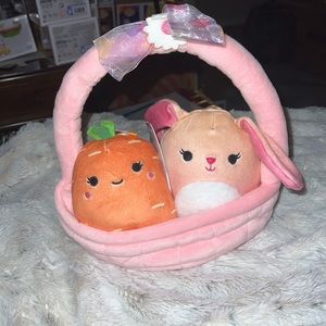 Caroleena the Carrot and Brinkley the Rabbit squishmallows in a Easter Basket.